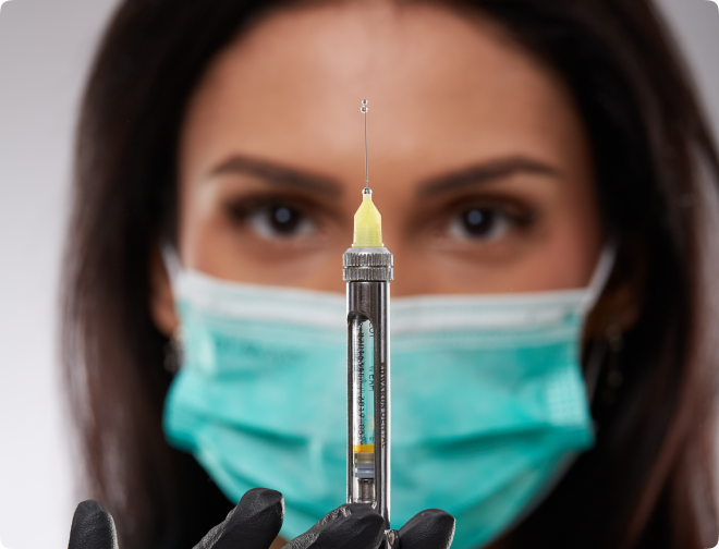 Dr Luisa holding a dental syringe Close-up