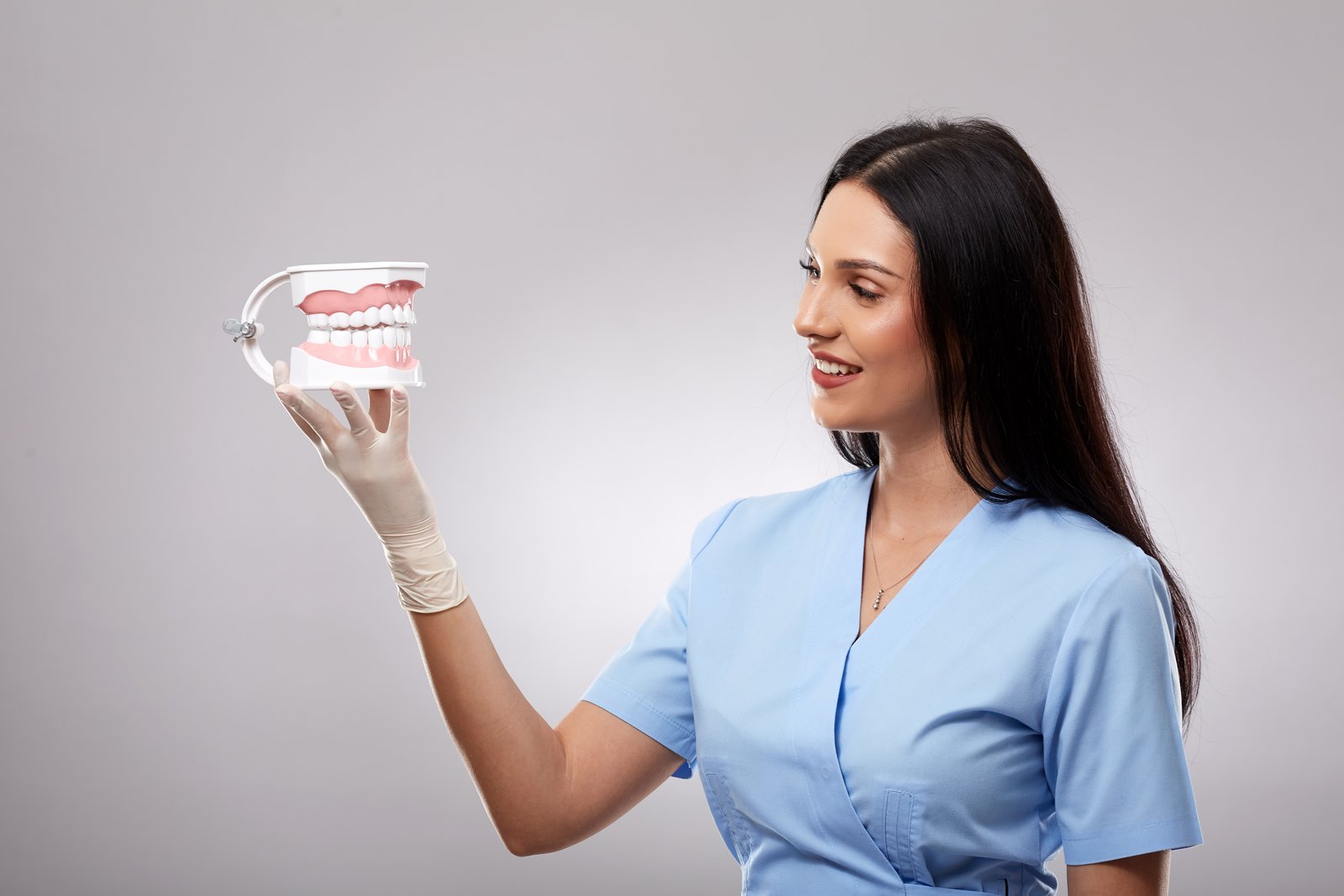Dr Luisa holding a dental model