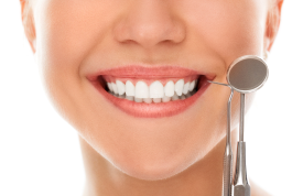 Close-up of a smile with a dental mirror